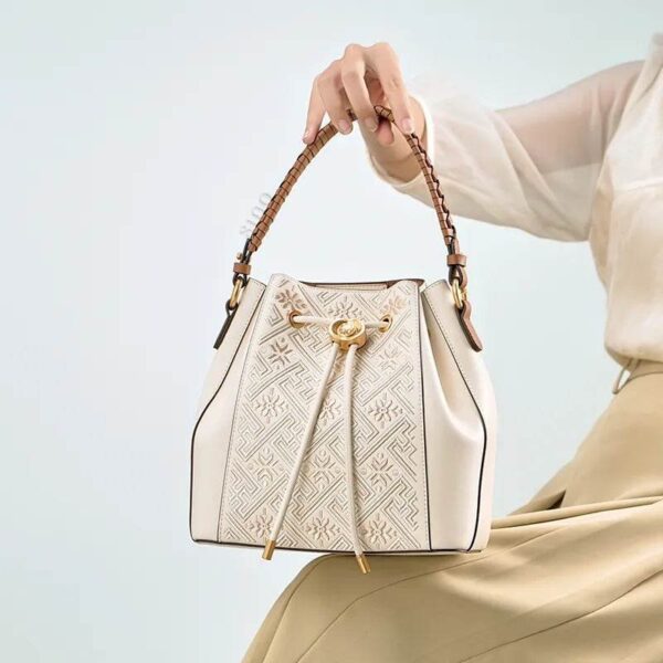 anj-pattern-embroidered-leather-convertible-backpack-tote-model-sitting-knee-handheld.jpg anj-pattern-embroidered-leather-convertible-backpack-tote-model-sitting-knee-handheld.jpg