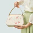 model-hand-holding-plum-blossom-bag.jpg