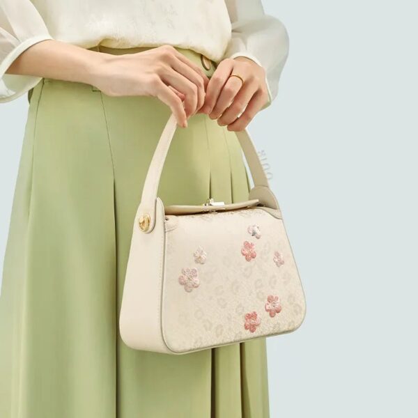 model-holding-plum-blossom-bag-both-hands-front.jpg model-holding-plum-blossom-bag-both-hands-front.jpg