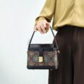 model-holding-song-brocade-bag-front.jpg
