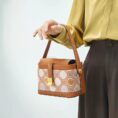 model-holding-zhuang-brocade-bag-single-hand.jpg
