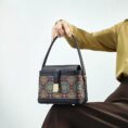 model-seated-song-brocade-bag-on-knees.jpg