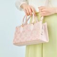 song-brocade-leather-handbag-pink-gold-dingsheng-motif-model-crossbody.jpg
