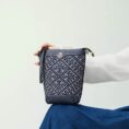 zhuang-brocade-bucket-crossbody-bag-model-blue-dress-sitting-knee.jpg